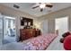 Comfortable main bedroom with a ceiling fan, ensuite bathroom, and views into the living area at 5646 Sunset Falls Dr, Apollo Beach, FL 33572