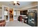 Home office featuring a desk, TV, safe, and glass doors leading to the kitchen at 5646 Sunset Falls Dr, Apollo Beach, FL 33572