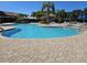 Inviting community pool area with clear blue water, comfortable lounge chairs, and lush tropical landscaping at 5646 Sunset Falls Dr, Apollo Beach, FL 33572