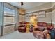 Cozy sitting room with two recliners, natural light, and aviation-themed decor at 5646 Sunset Falls Dr, Apollo Beach, FL 33572