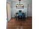 Cozy dining area featuring a black table, modern chandelier, and stylish decor, perfect for intimate meals at 603 Southwood Cv, Brandon, FL 33511