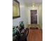 Inviting entryway with wood-look flooring, decor and a mirror at 603 Southwood Cv, Brandon, FL 33511