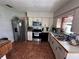 Well-lit kitchen with stainless steel appliances, functional layout, and tile flooring at 603 Southwood Cv, Brandon, FL 33511
