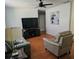 Living room offering wood-look flooring, a ceiling fan and comfortable furniture at 603 Southwood Cv, Brandon, FL 33511