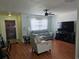 Open-concept living room showcasing a ceiling fan, wood-look floors, and natural light at 603 Southwood Cv, Brandon, FL 33511