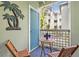 Relaxing balcony with seating and a decorative palm tree, perfect for outdoor enjoyment at 607 S Albany Ave # 1, Tampa, FL 33606