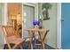 Relaxing balcony setup with table, chairs, wine, and a view to the kitchen inside the house at 607 S Albany Ave # 1, Tampa, FL 33606