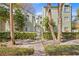 Charming two-story condo buildings with a walkway and gate surrounded by lush landscaping at 607 S Albany Ave # 1, Tampa, FL 33606