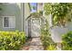 Charming garden gate entrance with lush greenery, adding character and privacy to the property at 607 S Albany Ave # 1, Tampa, FL 33606