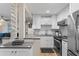 Charming kitchen featuring white cabinets, stainless appliances, and a stylish tile backsplash at 607 S Albany Ave # 1, Tampa, FL 33606