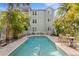 Beautiful backyard pool is surrounded by tropical plants, creating a private oasis for relaxation at 607 S Albany Ave # 1, Tampa, FL 33606