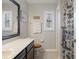 Bathroom has nice vanity, wood-look toilet seat, shower and nautical decor at 6303 Gentle Ben Cir, Wesley Chapel, FL 33544