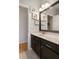 Bathroom with a vanity with a light countertop and dark cabinets and nautical decor at 6303 Gentle Ben Cir, Wesley Chapel, FL 33544