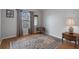 This bedroom has wood floors, a patterned rug, and large window with natural light at 6303 Gentle Ben Cir, Wesley Chapel, FL 33544