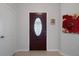 Inviting foyer featuring a decorative glass front door and neutral wall paint at 6303 Gentle Ben Cir, Wesley Chapel, FL 33544