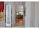 Hallway featuring views into the living room, enhanced by the home's neutral wall paint at 6303 Gentle Ben Cir, Wesley Chapel, FL 33544