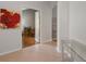 Hallway featuring neutral decor and views into the adjacent rooms at 6303 Gentle Ben Cir, Wesley Chapel, FL 33544