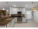 Updated kitchen with stainless steel appliances and granite countertops at 6303 Gentle Ben Cir, Wesley Chapel, FL 33544