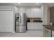Modern kitchen features stainless steel appliances, granite countertops and white cabinets at 6303 Gentle Ben Cir, Wesley Chapel, FL 33544