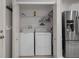 A laundry closet features a full size washer and dryer with wire shelving for storage above at 6303 Gentle Ben Cir, Wesley Chapel, FL 33544