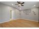 Bright and airy living room with wood floors, neutral walls, a ceiling fan and access to a bedroom at 6303 Gentle Ben Cir, Wesley Chapel, FL 33544