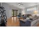 Spacious living room features wood floors, ceiling fan, and sliding glass door to the outside at 6303 Gentle Ben Cir, Wesley Chapel, FL 33544