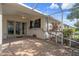 The screened-in patio features brick flooring and a wall mural and backs to a yard at 6303 Gentle Ben Cir, Wesley Chapel, FL 33544