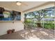 This screened-in patio has brick flooring and a wall mural at 6303 Gentle Ben Cir, Wesley Chapel, FL 33544