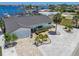 Aerial view of home with a two car garage, lush landscaping and waterfront access at 6322 Cocoa Ln, Apollo Beach, FL 33572