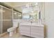 Bright bathroom features a modern vanity, toilet and a shower, all complemented by neutral tiling at 6322 Cocoa Ln, Apollo Beach, FL 33572