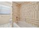 Bathroom highlighting the tub/shower combination, tiled walls, and minimalist design, creating a clean and functional space at 6322 Cocoa Ln, Apollo Beach, FL 33572