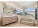 Bright and open bathroom with garden tub, separate shower, dual sink vanity and plenty of mirror space at 6322 Cocoa Ln, Apollo Beach, FL 33572