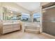 Bright and open bathroom with garden tub, separate shower, dual sink vanity and plenty of mirror space at 6322 Cocoa Ln, Apollo Beach, FL 33572