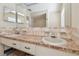 Bathroom featuring double sinks, linoleum counter, and a mirrored backsplash adding character to this functional space at 6322 Cocoa Ln, Apollo Beach, FL 33572