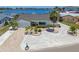 Inviting single-story waterfront home featuring lush landscaping, a brick driveway, and breathtaking ocean views at 6322 Cocoa Ln, Apollo Beach, FL 33572