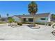 Charming home with a meticulously landscaped yard featuring palm trees and decorative rock at 6322 Cocoa Ln, Apollo Beach, FL 33572