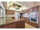 Kitchen with granite countertops, stainless appliances and dark wood cabinetry at 6322 Cocoa Ln, Apollo Beach, FL 33572