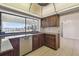 Cozy kitchen features dark wood cabinetry, granite countertops and a picturesque water view from its expansive window at 6322 Cocoa Ln, Apollo Beach, FL 33572
