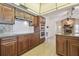 Well equipped kitchen features dark wood cabinetry, stainless steel appliances and a stone fireplace in the adjacent room at 6322 Cocoa Ln, Apollo Beach, FL 33572