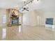 Spacious living room with stone fireplace, ceiling fan, and access to other rooms; aquarium is also visible at 6322 Cocoa Ln, Apollo Beach, FL 33572