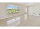 Bright living room with elegant tiled floors, a large window, and glass doors, offering a serene and inviting atmosphere at 6322 Cocoa Ln, Apollo Beach, FL 33572