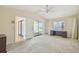 Carpeted main bedroom featuring ceiling fan, exterior access and en suite bathroom at 6322 Cocoa Ln, Apollo Beach, FL 33572