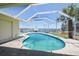Enjoy waterfront views from the screened-in pool area surrounded by stone tile, and lush landscaping at 6322 Cocoa Ln, Apollo Beach, FL 33572