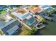 Beautiful aerial view of a canal-front home featuring a screened pool, boat dock, and lush landscaping at 6508 Senegal Palm Way, Apollo Beach, FL 33572
