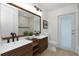 Bathroom features double sink, marble countertops, white subway tile in the shower, and wood cabinetry at 6508 Senegal Palm Way, Apollo Beach, FL 33572