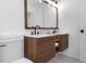 Contemporary bathroom featuring a wood vanity with sleek, modern design and double sinks at 6508 Senegal Palm Way, Apollo Beach, FL 33572