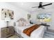 Bright bedroom featuring a comfortable bed, matching nightstands, and contemporary artwork at 6508 Senegal Palm Way, Apollo Beach, FL 33572
