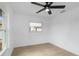 Bright bedroom features a ceiling fan, window and light-colored wood-look flooring at 6508 Senegal Palm Way, Apollo Beach, FL 33572