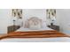 Bright bedroom featuring a luxurious bed, matching nightstands, and contemporary artwork at 6508 Senegal Palm Way, Apollo Beach, FL 33572