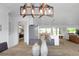 Stylish dining area with custom light fixture, seamlessly connected to the kitchen and living spaces at 6508 Senegal Palm Way, Apollo Beach, FL 33572